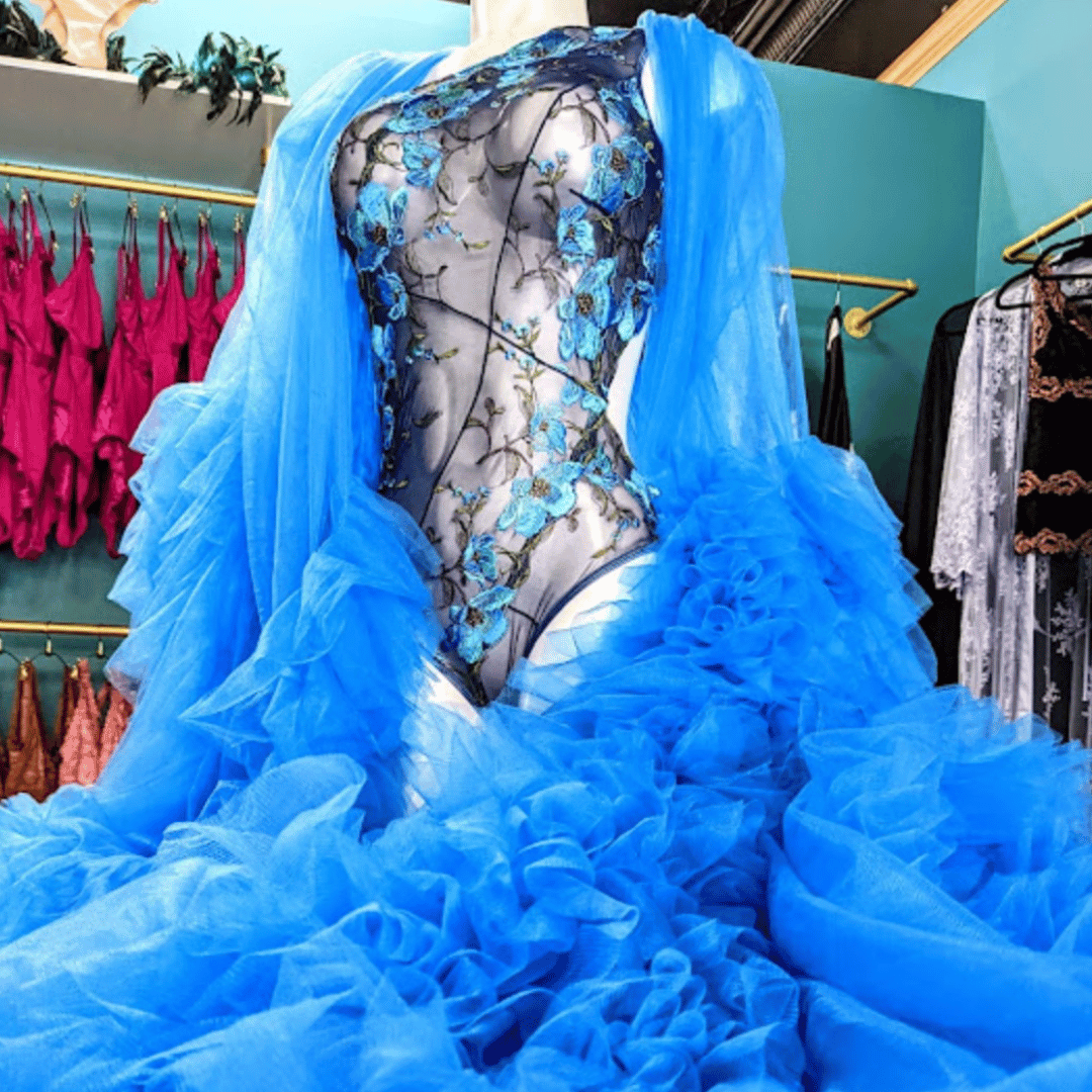 Carol Coehlo blue floral bodysuit under a flowing blue tulle glamour robe