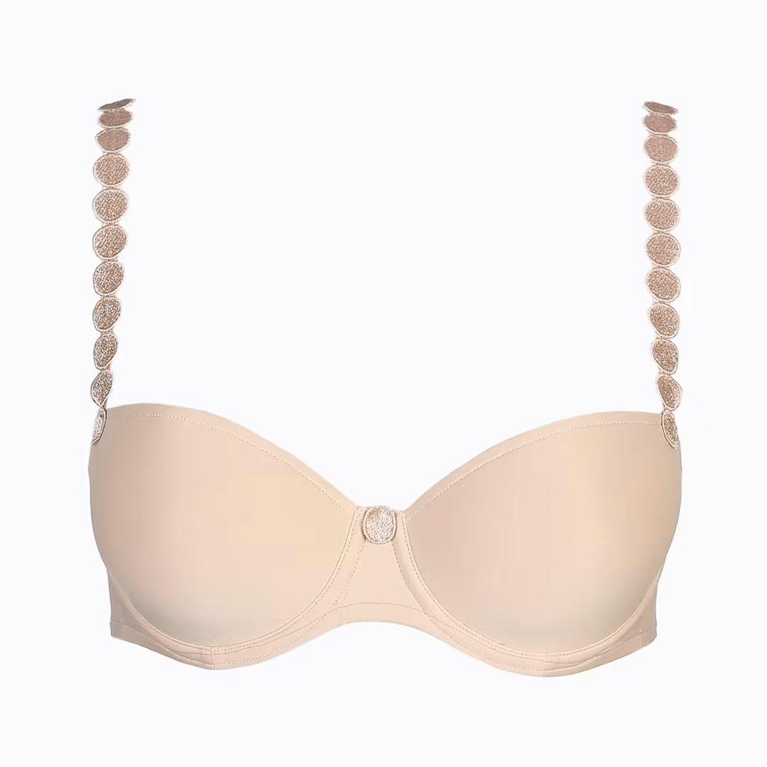 Beige bra with decorative straps on a white background