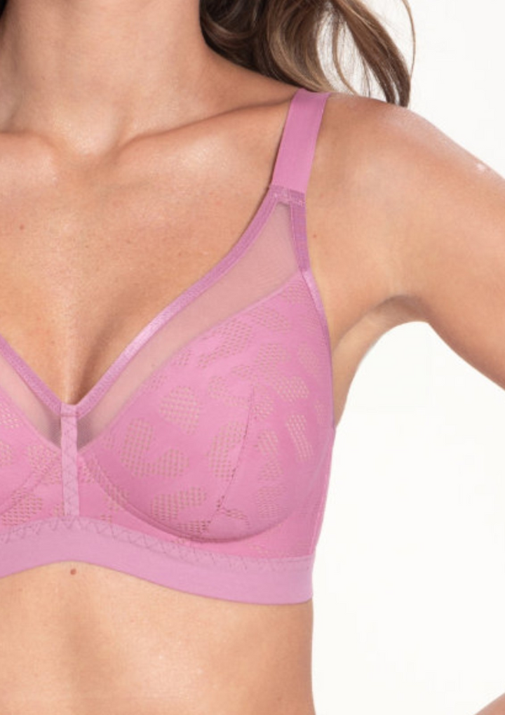 Pink bra worn by a person on a white background