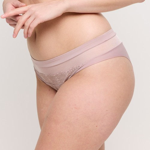Person wearing a pair of pink lace underwear on a plain background