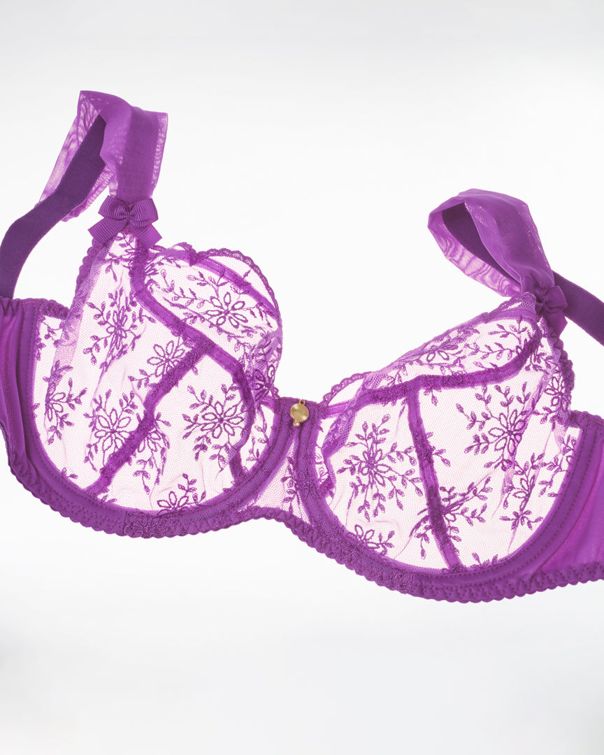 Purple lace bra on a white background