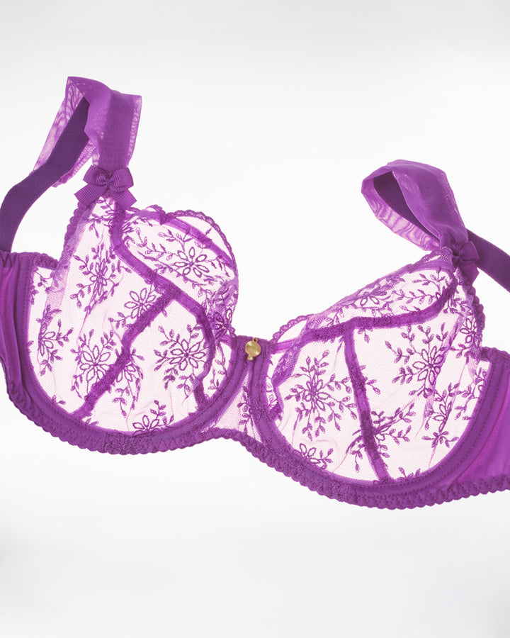Purple lace bra on a white background