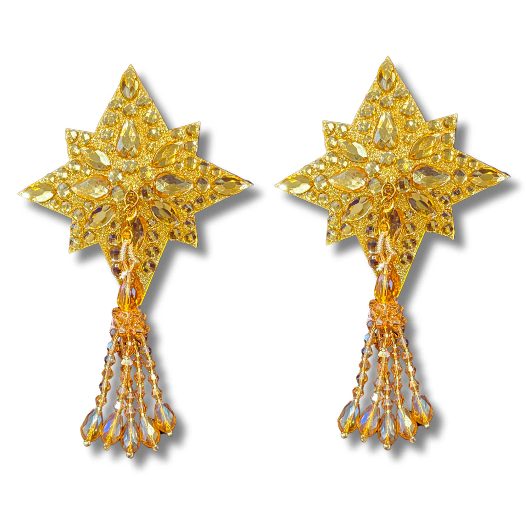 Gold star-shaped earrings with tassels on a white background
