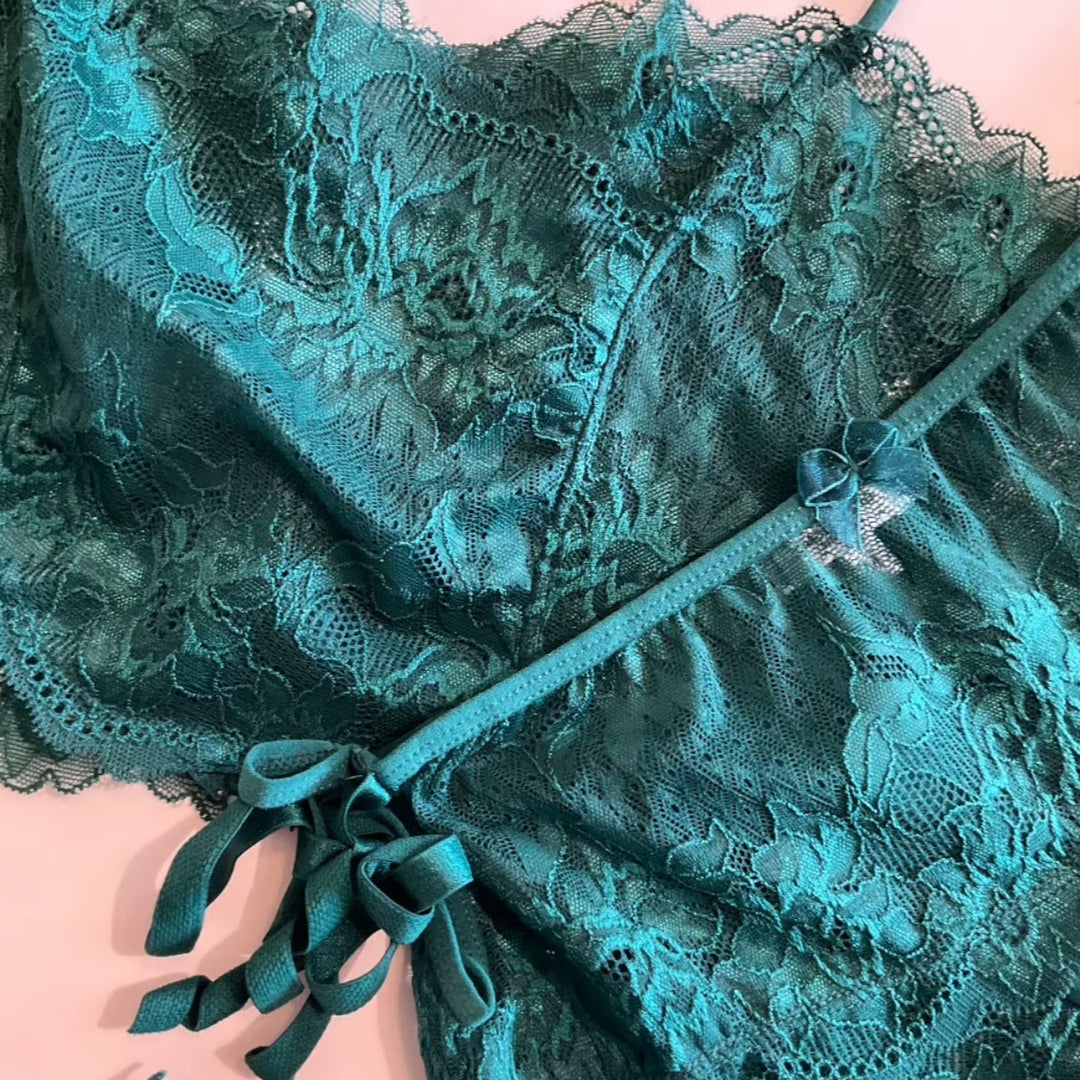 Teal lace lingerie set on a beige background