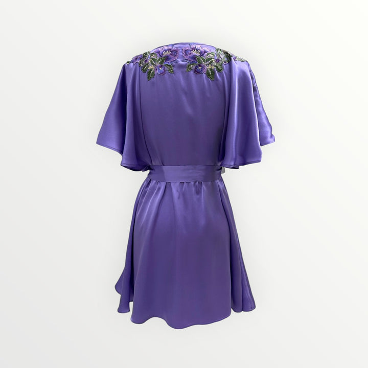 Purple dress with floral embellishments on a white background