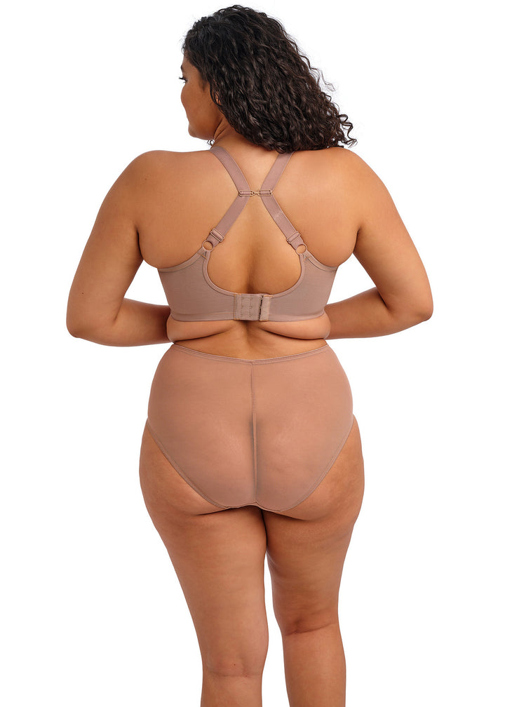 Woman wearing a beige shapewear bodysuit on a white background