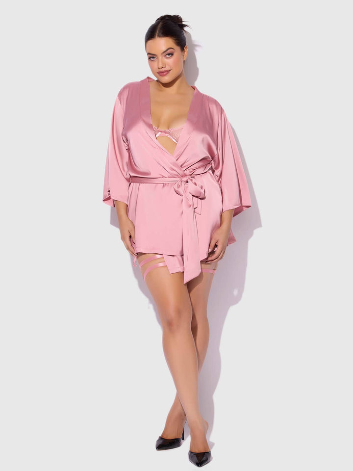 Woman wearing a pink romper on a white background