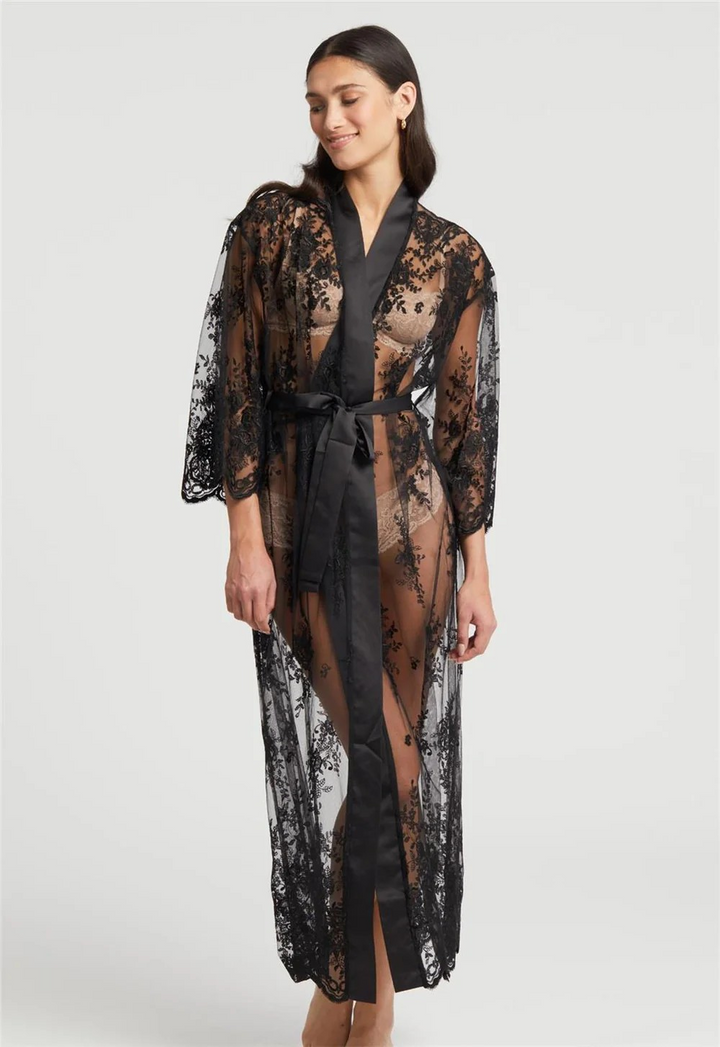 Woman wearing a black lace robe on a white background