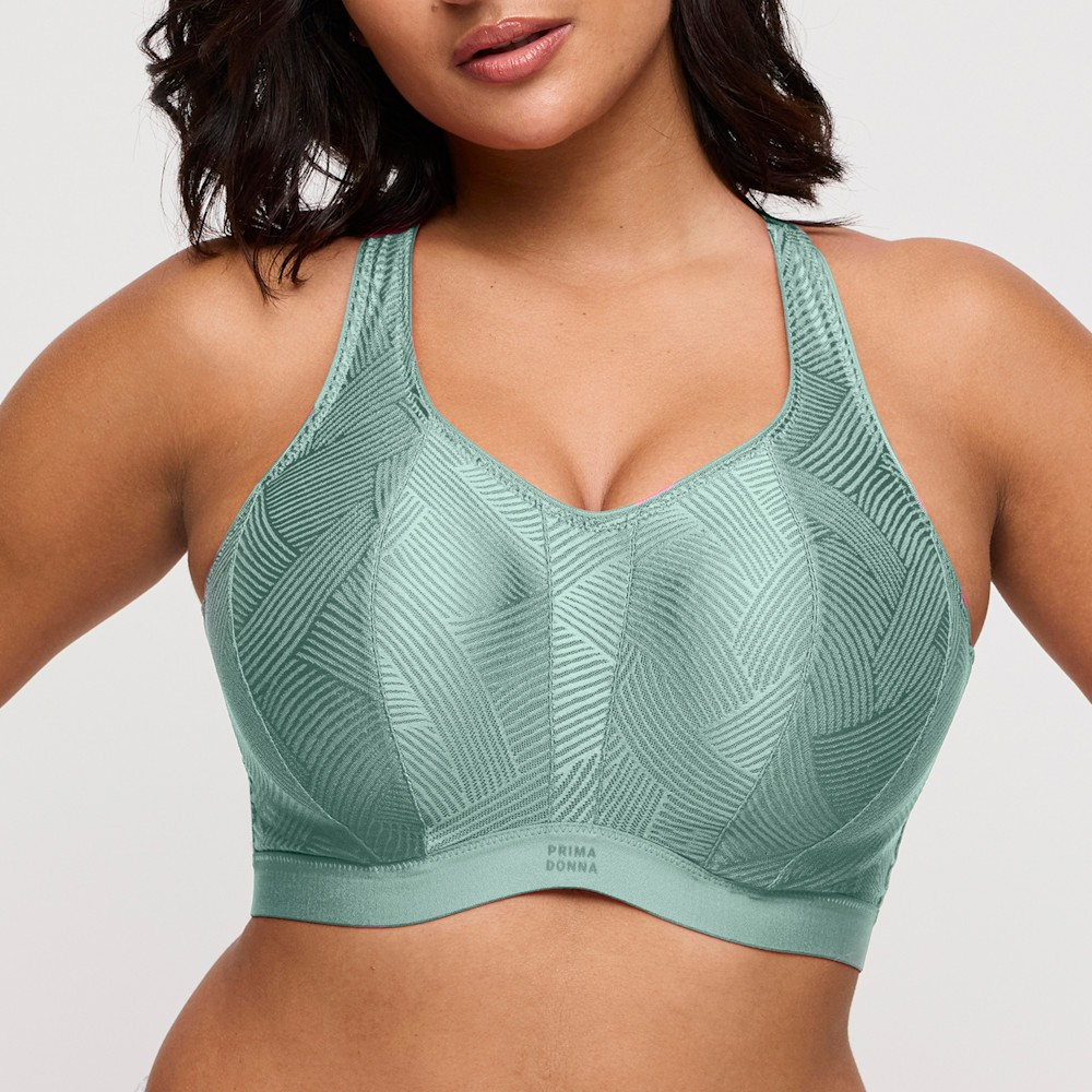 Green patterned sports bra worn by a model on a white background
