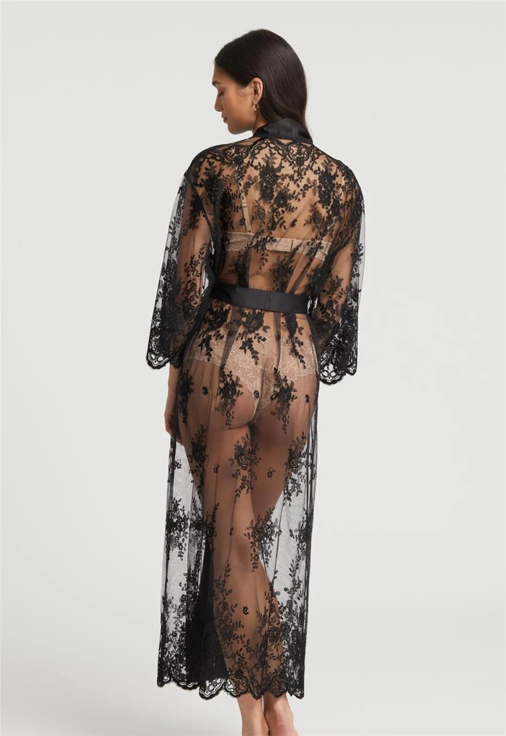 Black lace robe worn by a model on a white background