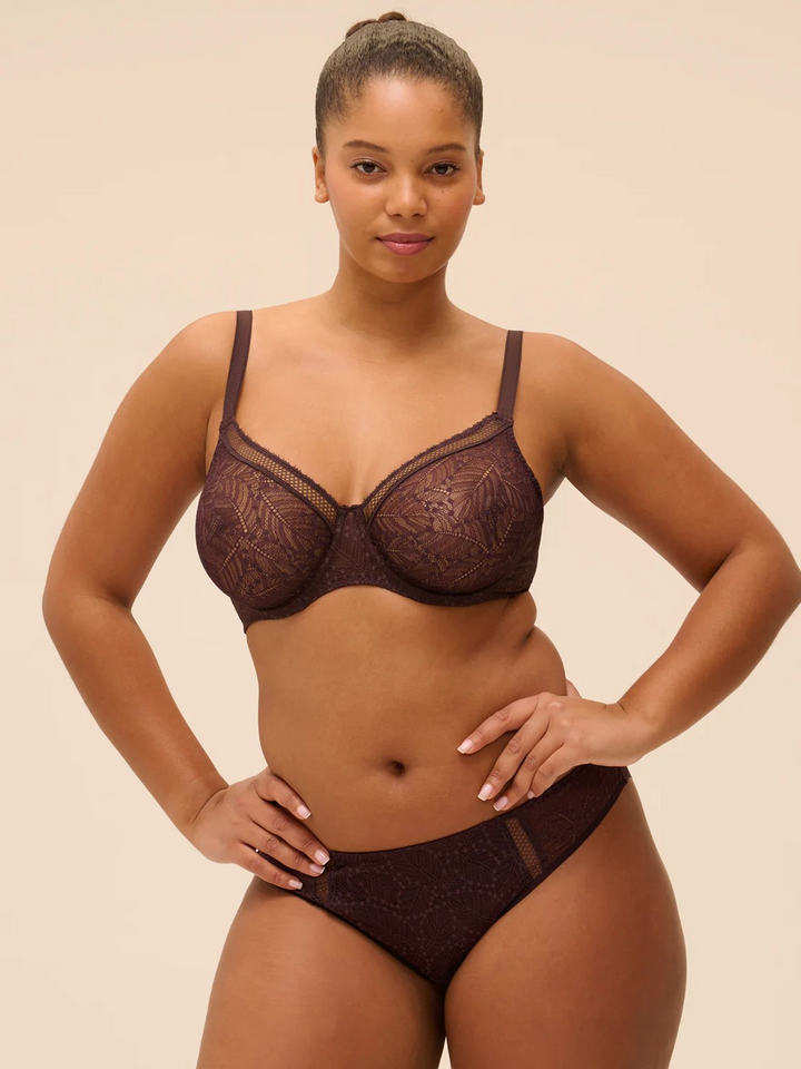 Simone Perele french lingerie Woman wearing a dark brown lingerie set against a beige background