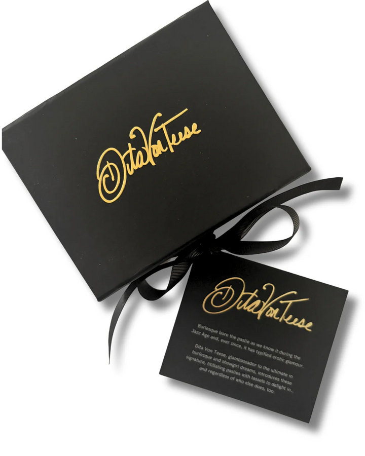 Black gift box with gold text and a black card on a white background