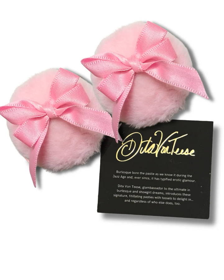 Pink fluffy pasties with a bow and a card displaying a brand name on a white background